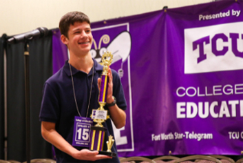 Speller holding trophy